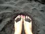 Pink toes on black sand